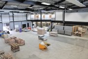 An empty construction space with tables, titles and bricks on pallets