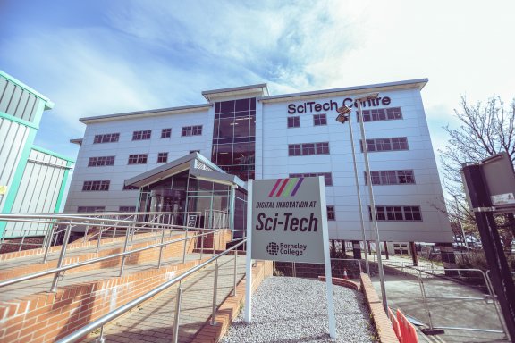 The scitech digital innovation hub. It is a grey building with lots of windows.