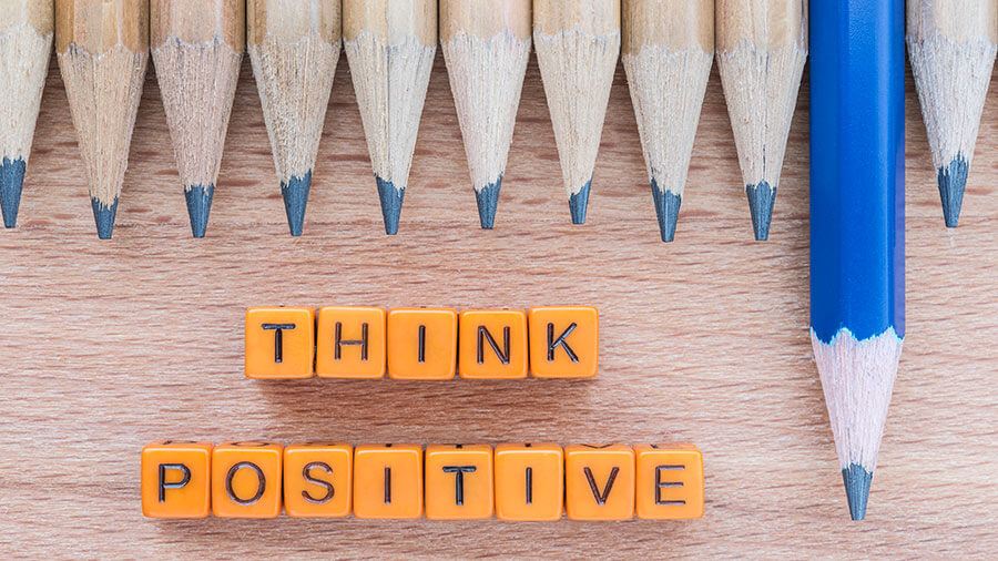 Row of pencils with blocks saying Think Positive 