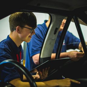 Students working on a car.