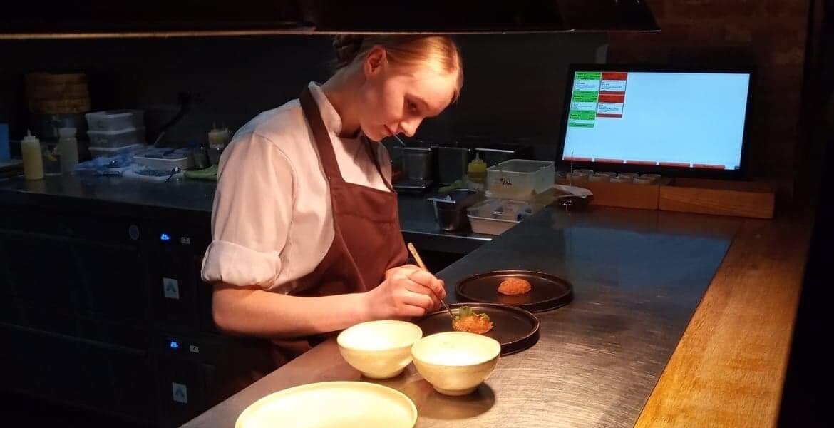 Beata preparing food at Roots restaurant in York.