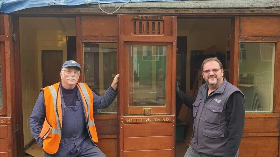 Allan Halman and Peter Cox from Hull and Barnsley Railway Stock Fund with the train carriage.