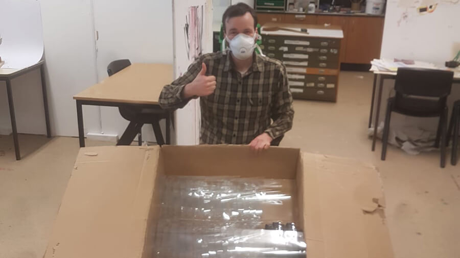 Bradley Sharp with some of the first visors, packaged and ready to go to Barnsley Hospital.