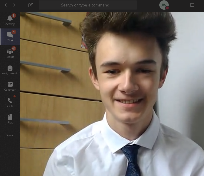 Interview picture of student in suit taken through online call camera