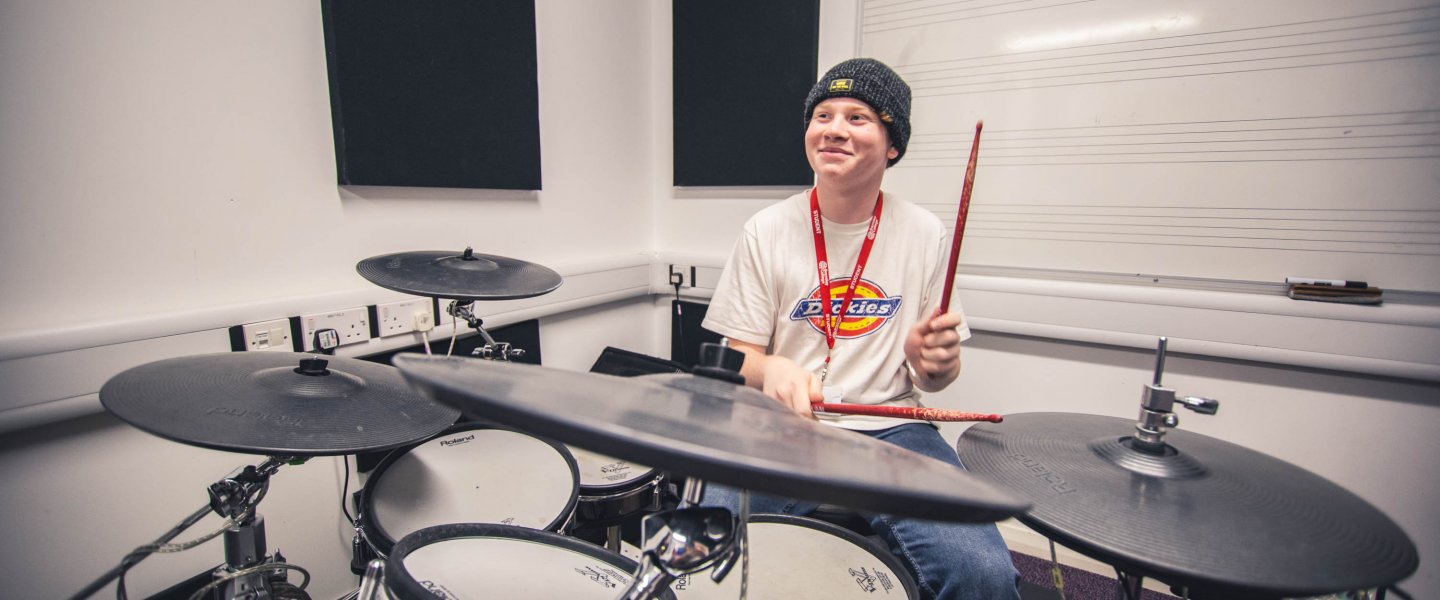 student playing drums