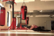 Person doing splits in boxing gym.