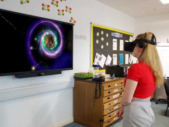 A Barnsley College Childcare and Education Professions student using the VR equipment to explore life as a new-born.
