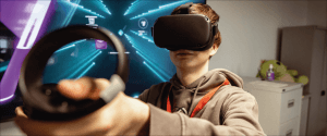 a boy with a VR headset on his eyes holding up a VR remote