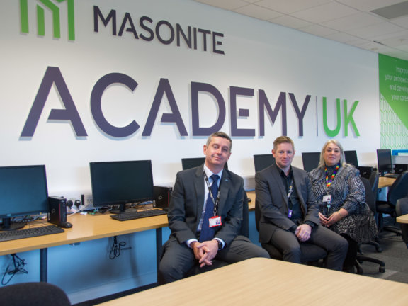 Barnsley College staff pictured next to Masonite sign