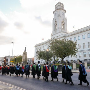 line of students in graduation gowns and caps