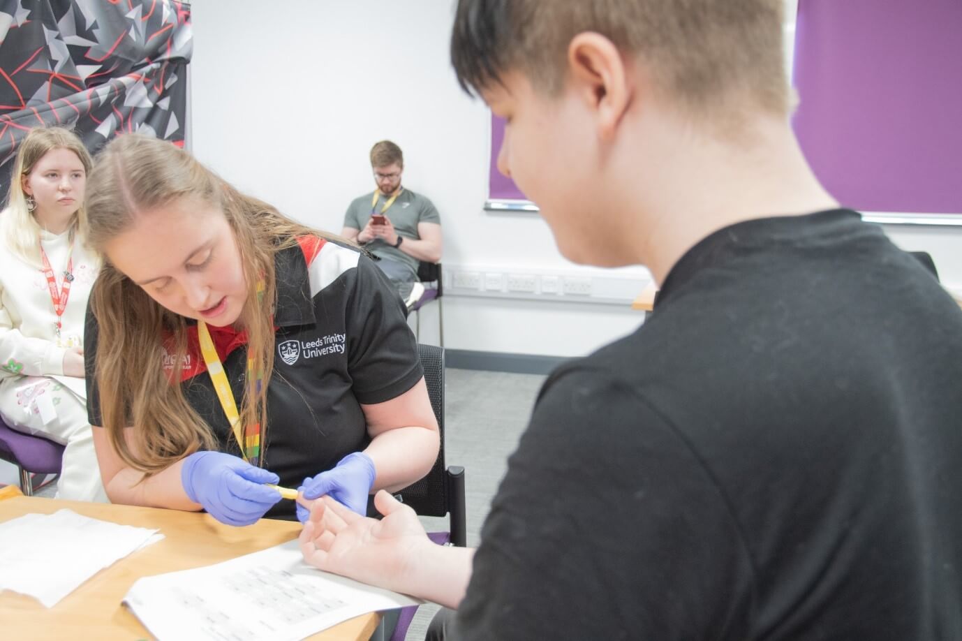 A student having a finger prick test done