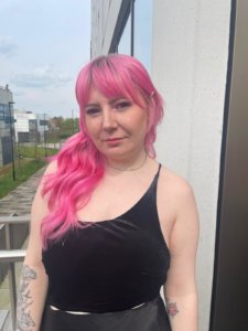 : Holly Oldfield ready for attending the UK Hair and Beauty Awards 2023 red carpet final event, smiling with pink long hair.