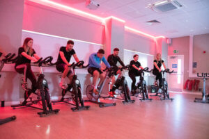 Photograph two - Student Services staff members in a spin class with Ryan Swain, second from left.