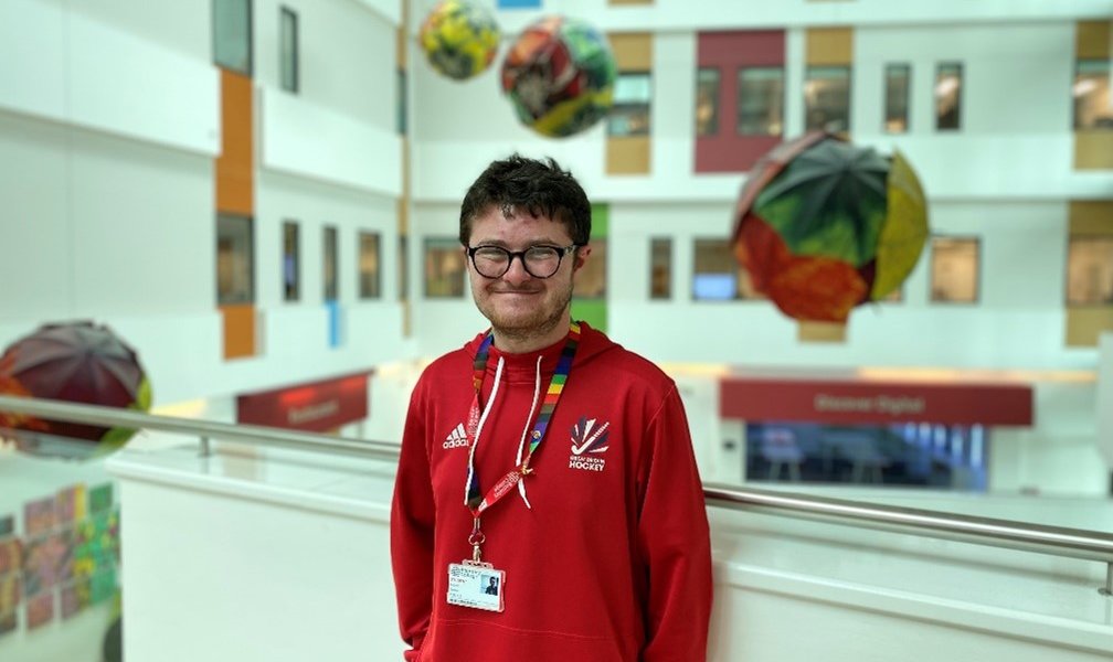 Barnsley College student Rob Crosse, member of the Special Olympics 2023 GB hockey squad, wearingbhis Speical Olympics GB top and smiling at the camera.