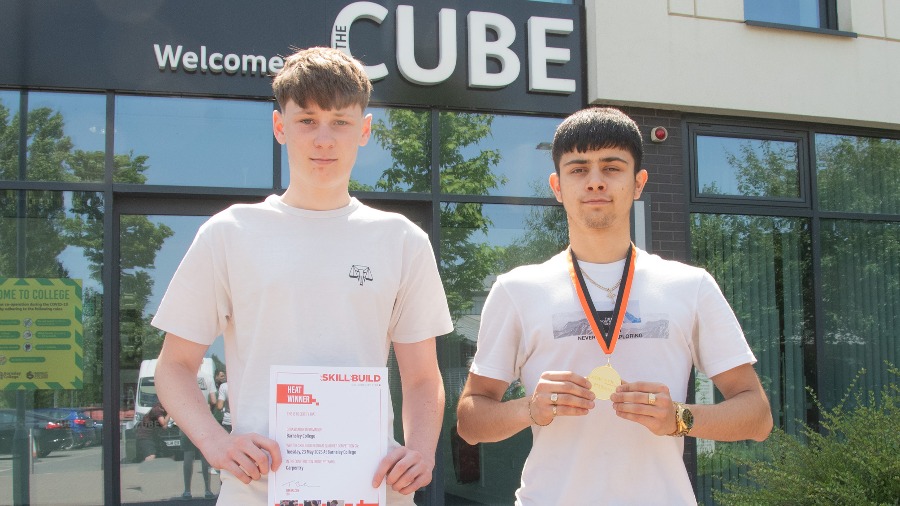 Photo of Thomas Cooze (right) holding his winner’s medal and George Robson (left) with his second place certificate.