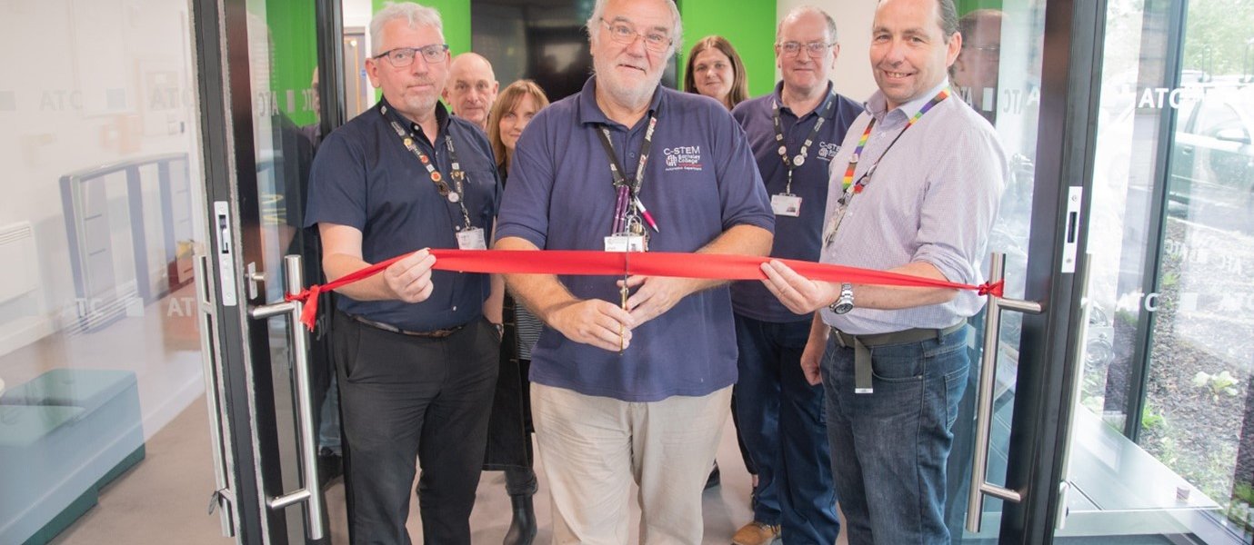 The Automotive Technologies teaching team, with longest-serving department staff member Michael Cumming set to cut the ribbon.