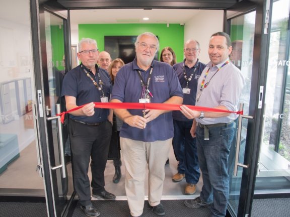 The Automotive Technologies teaching team, with longest-serving department staff member Michael Cumming set to cut the ribbon.
