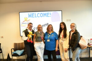 Robot Reg the puppet and Annie (central) with Childcare and Education Professions students.