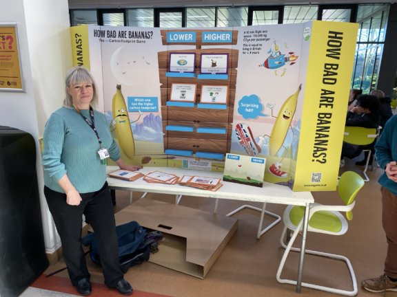 Mags Alderson with a banana sustainability game in the atrium at the Old Mill Lane campus.