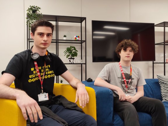 Jamie Baines and Elliot Barton, two T Level students who are finalists in the national Enginuity Skills Awards. Jamie, on the left, sits on a yellow armchair and Elliot is to the right on a blue sofa in a neutral-coloured TV studio.